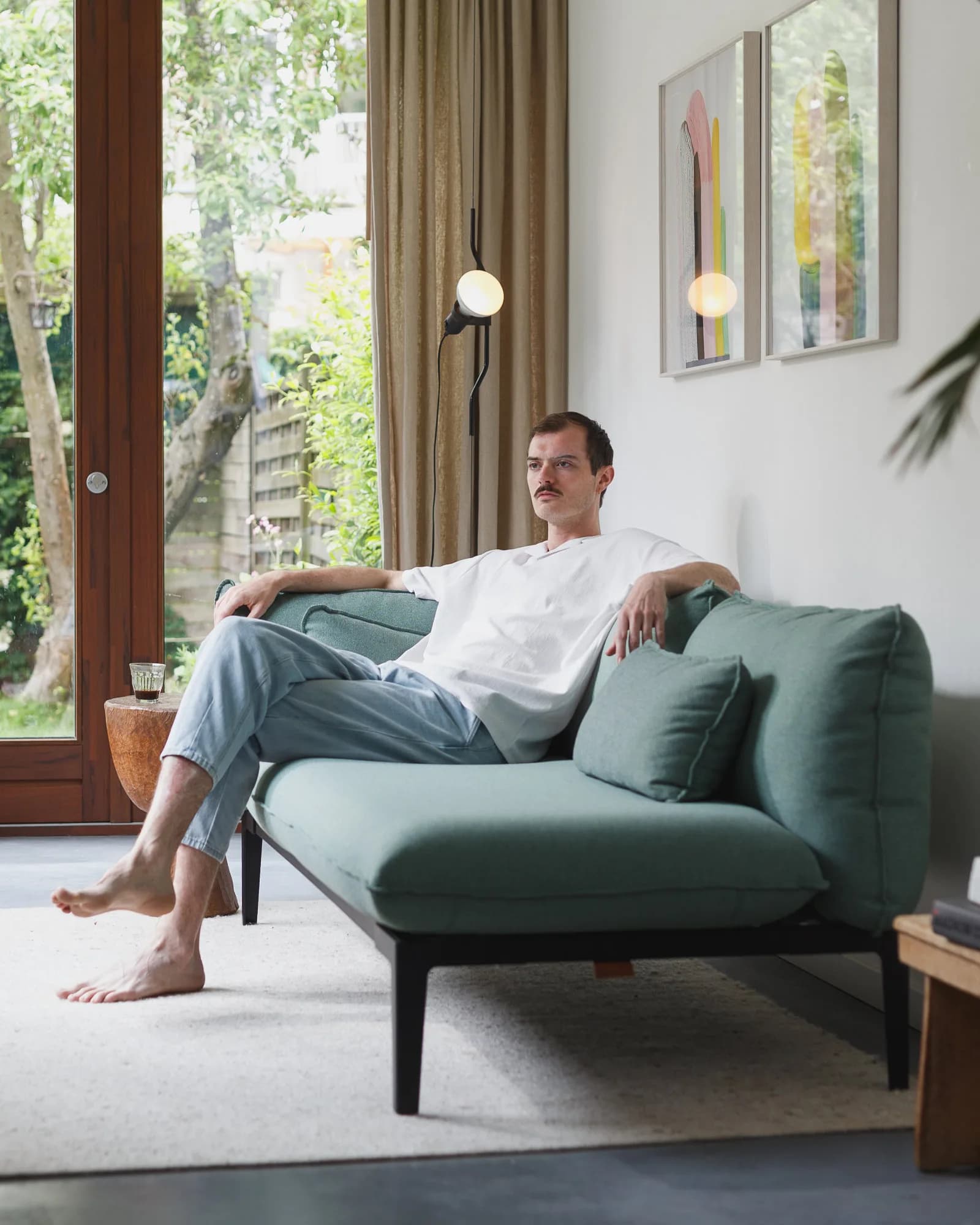 Man sitting on sofa with Kairos furniture